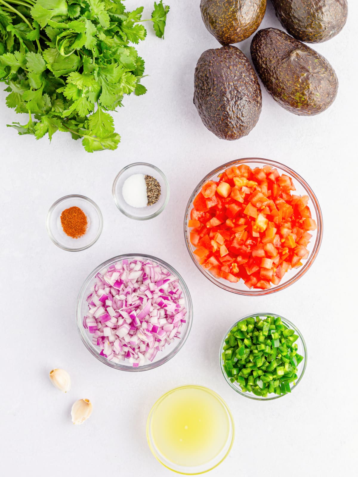fresh guacamole ingredients in prep bowls