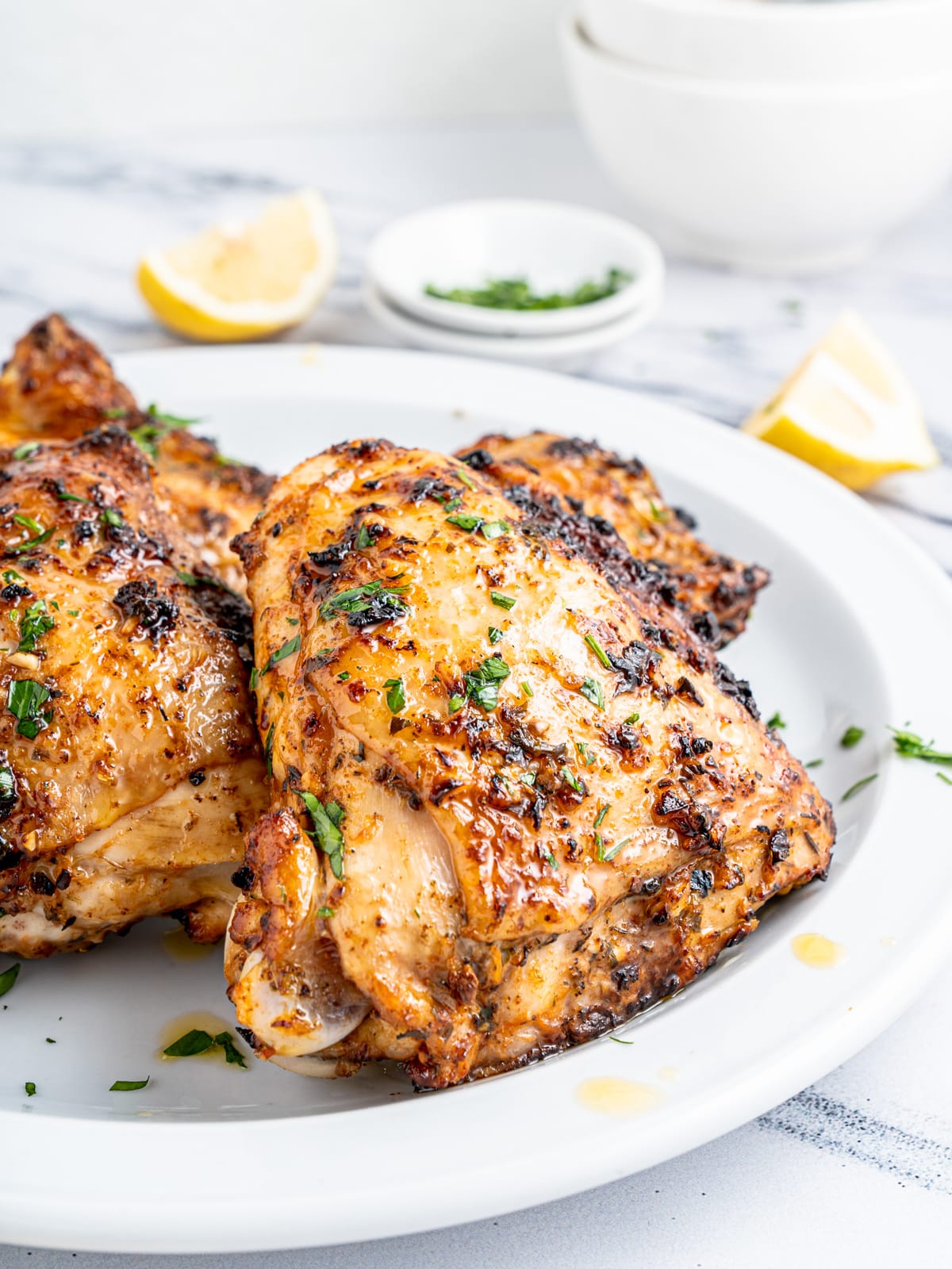 garnish chicken with herbs and lemon and serve
