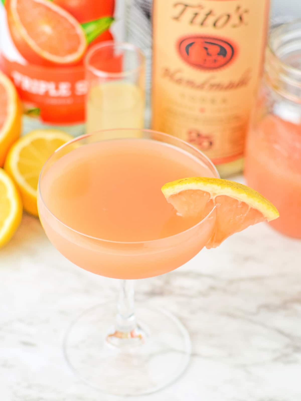 pour grapefruit martini into glass and enjoy