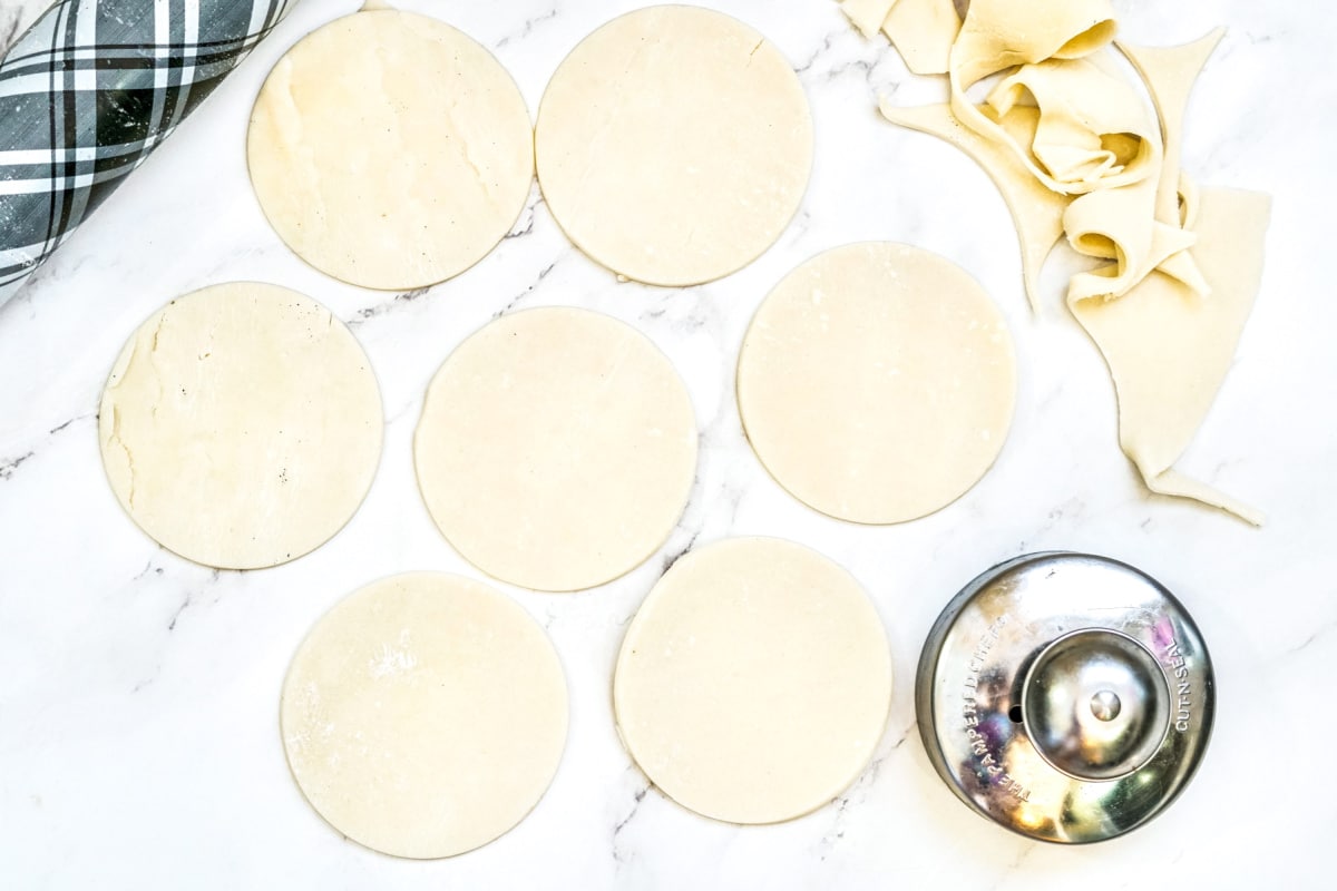 roll pie crust and cut pieces with a circle cutter