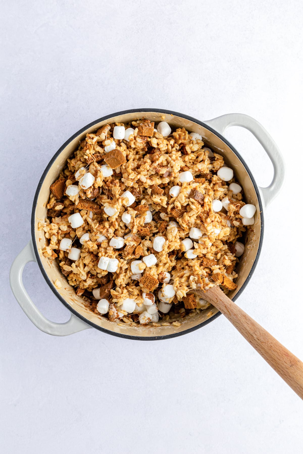 stir in reserved mini marshmallows to cereal treats in pot