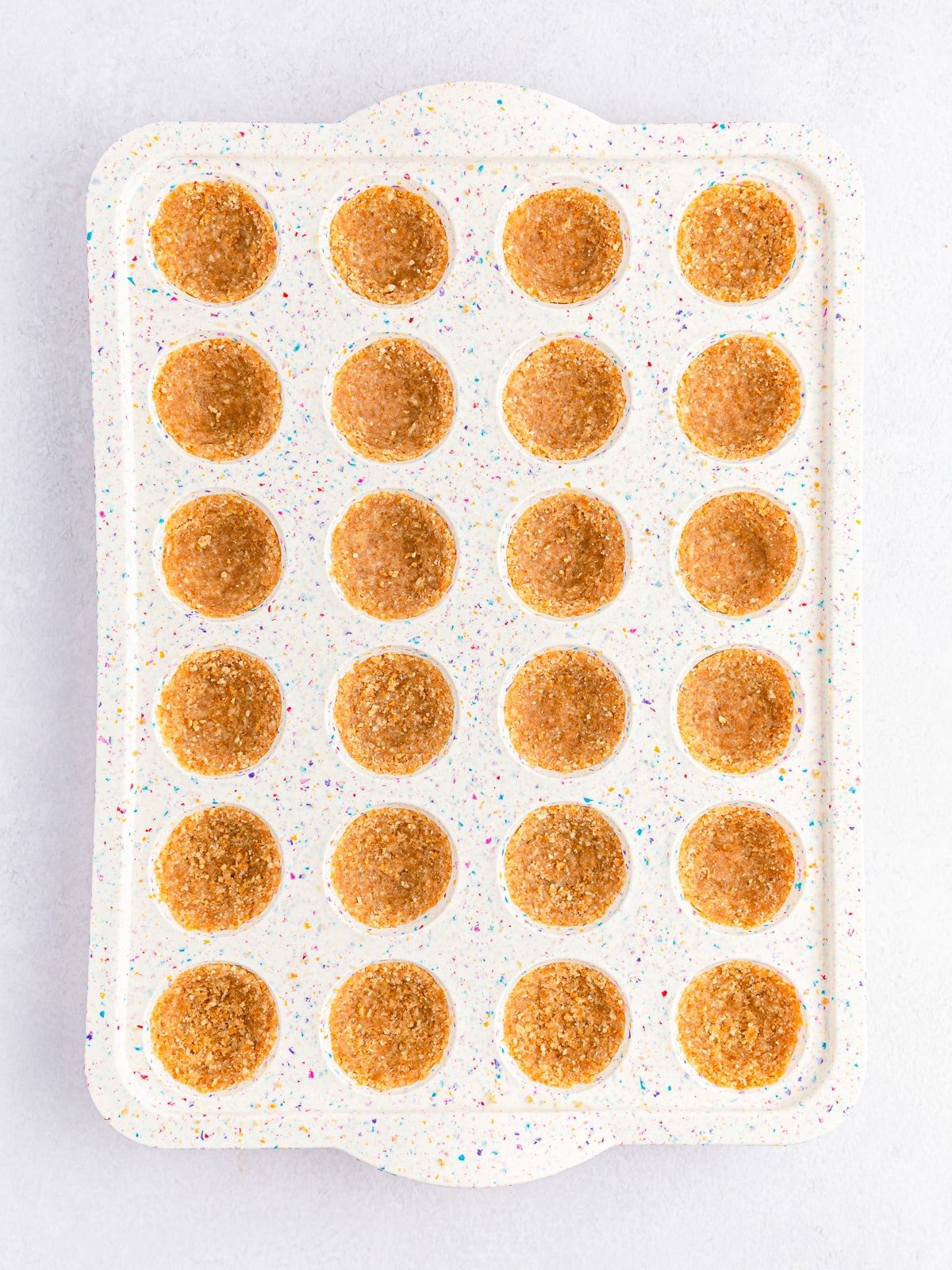 press cookie mixture into mini muffin pan.