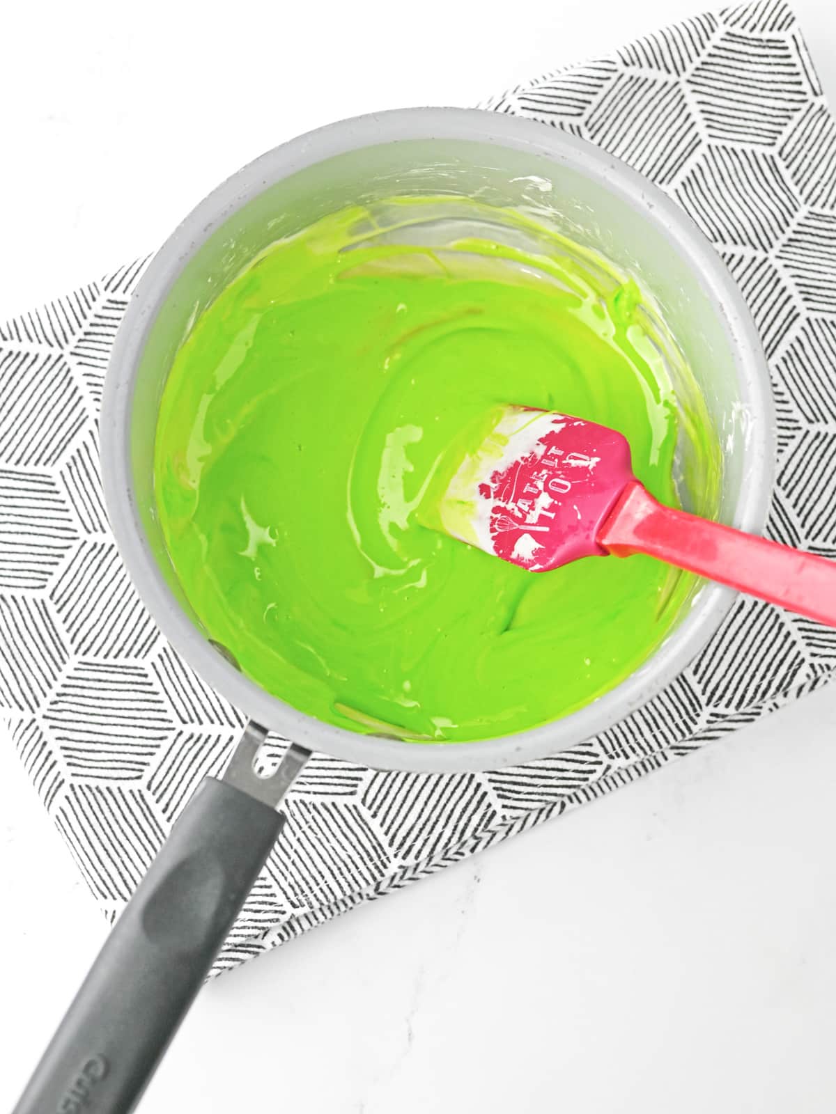 add green food coloring to melted marshmallows