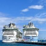Two cruise ships docked at a dock.