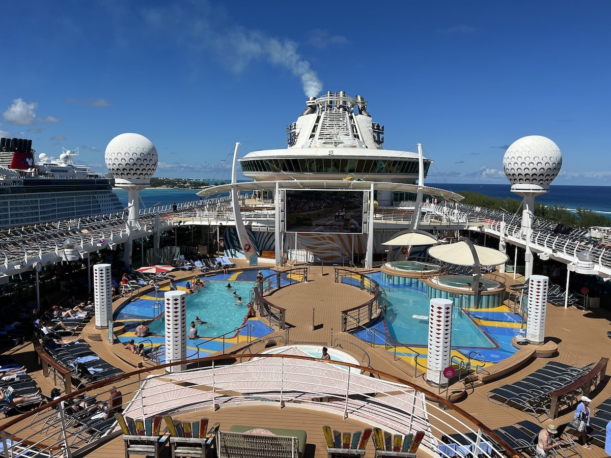 The deck of a cruise ship with a swimming pool.