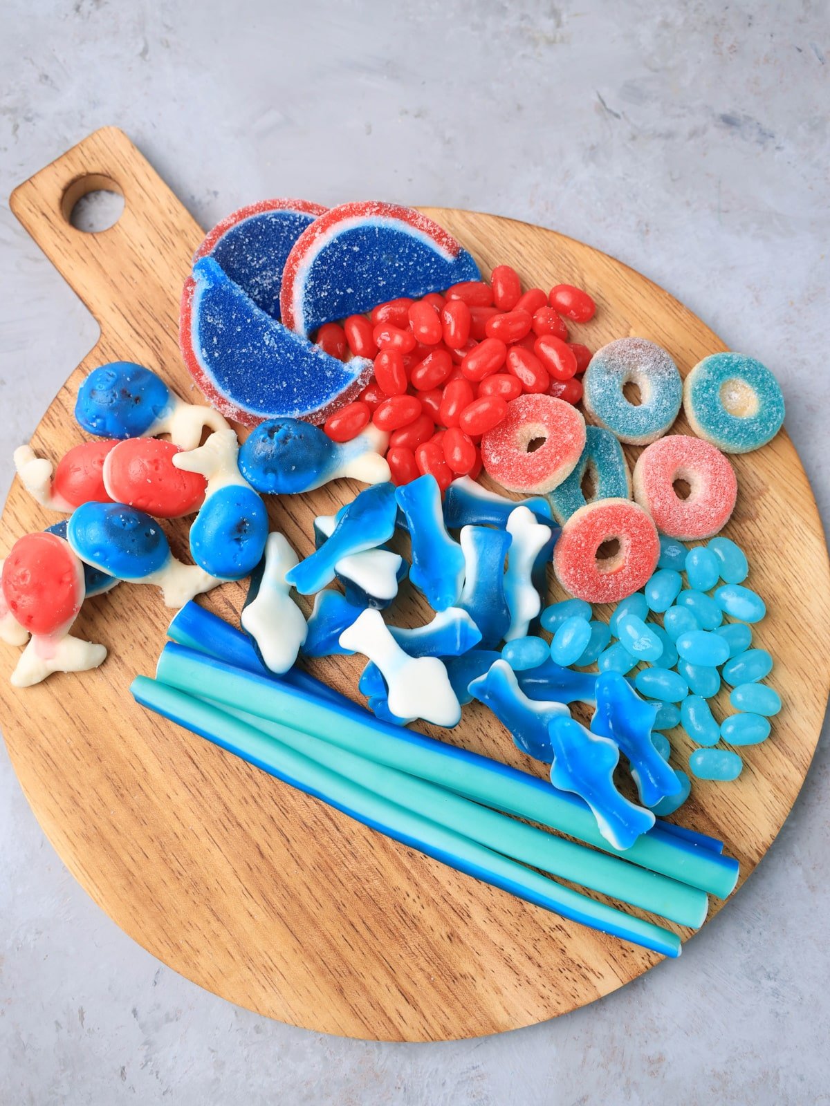 4th of july candy on a wooden cutting board.