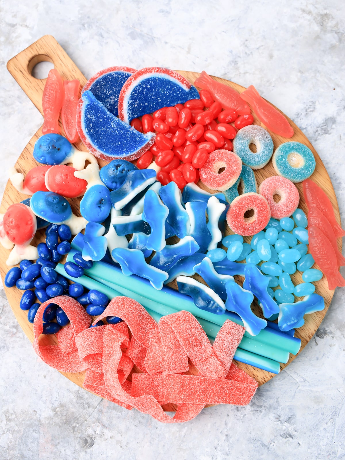 shark and fish candy bar on a wooden cutting board.