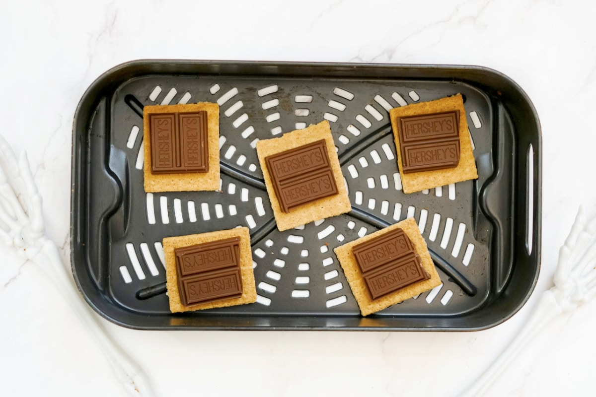 graham cracker squares with two hershey chocolate pieces on each