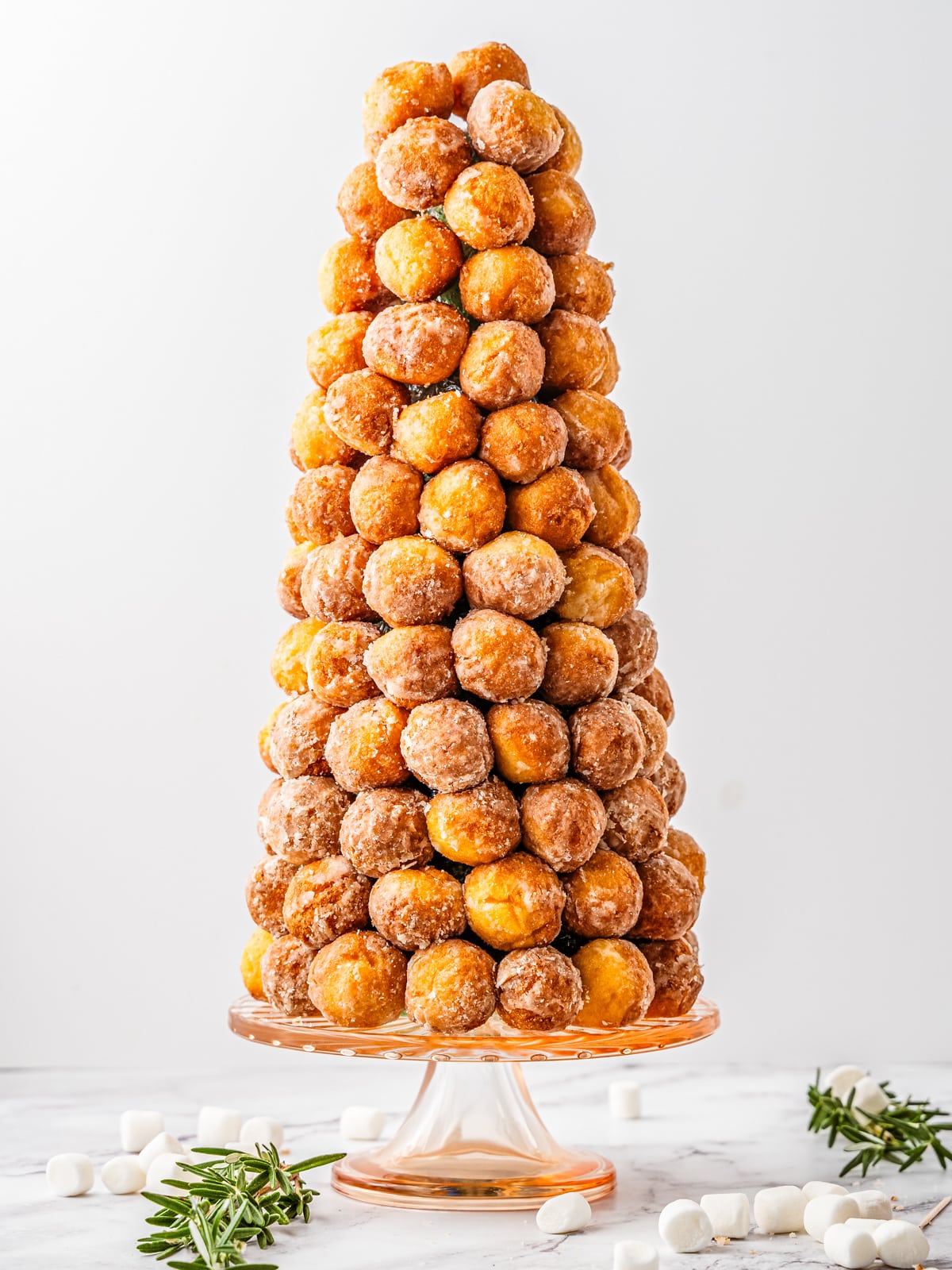 Styrofoam cone covered with donut holes.