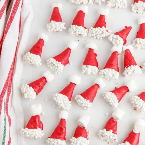 Santa hat cookies on a white plate.