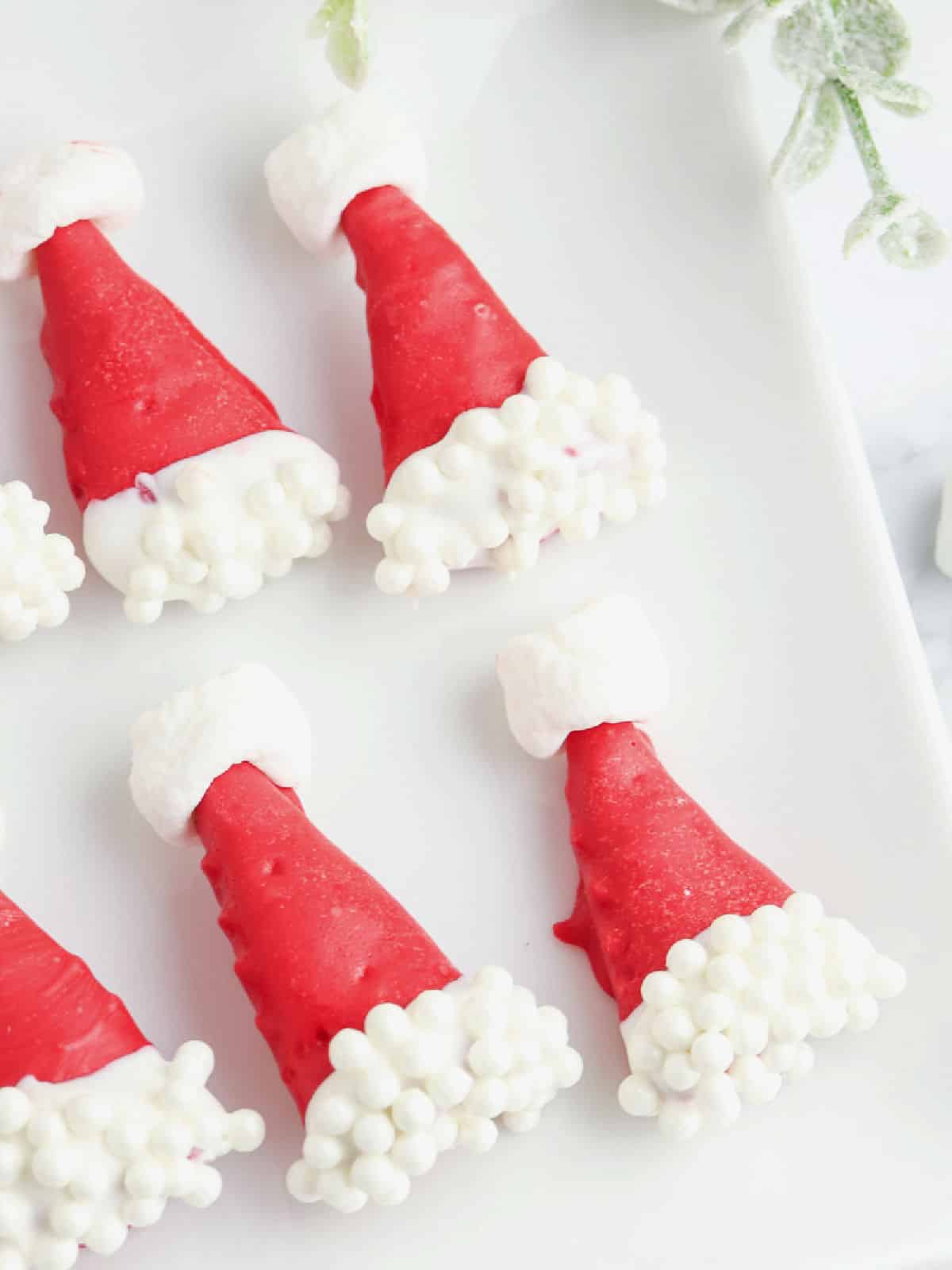 Bugle Santa Hats cookies on a white plate.