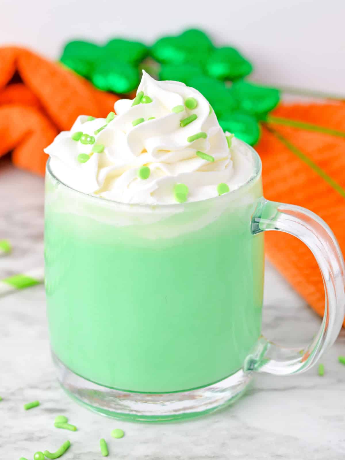 St patrick's day hot chocolate with whipped cream and green sprinkles.