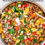Colorful greek-style ground beef skillet meal with vegetables, served in a pan.