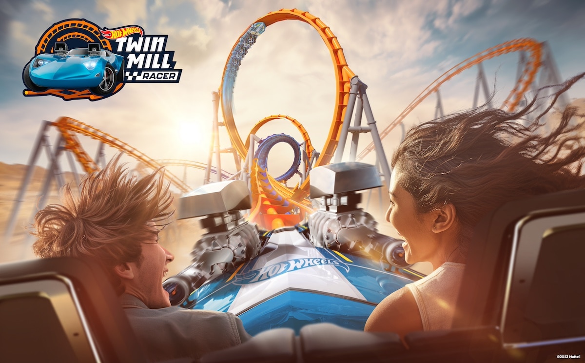 Two individuals enjoying a thrilling rollercoaster ride modeled after the hot wheels twin mill car.