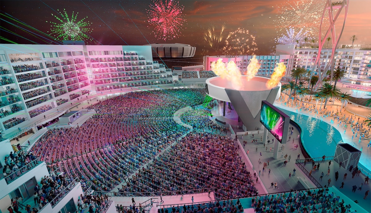A vibrant and crowded outdoor amphitheater with fireworks and a flamboyant stage performance.