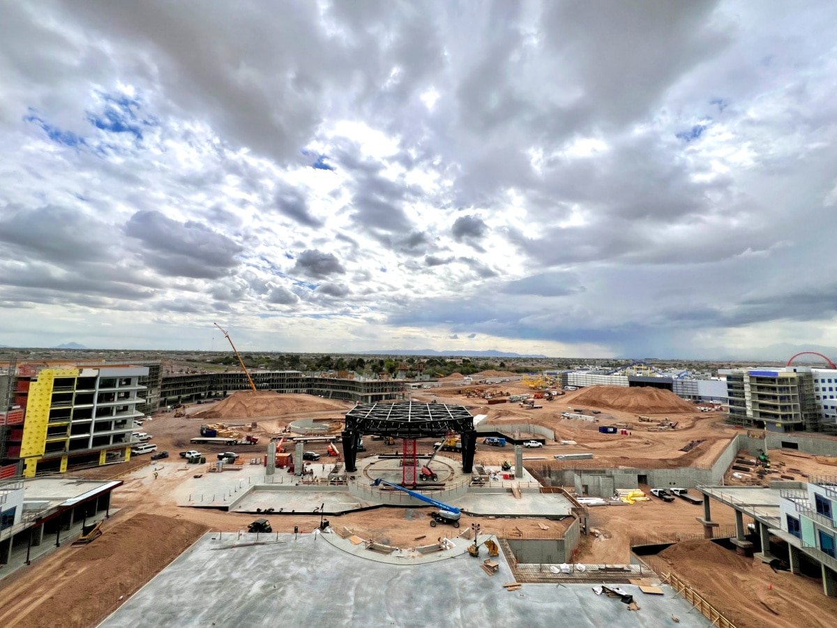 Construction site of the VAI Resort with ongoing work and a steel structure in the center under a cloudy sky.