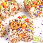 Close-up of vibrant Halloween rice krispie treats topped with pretzels, candy corn, and colorful sprinkles. A "Read More" button is visible on the right side.