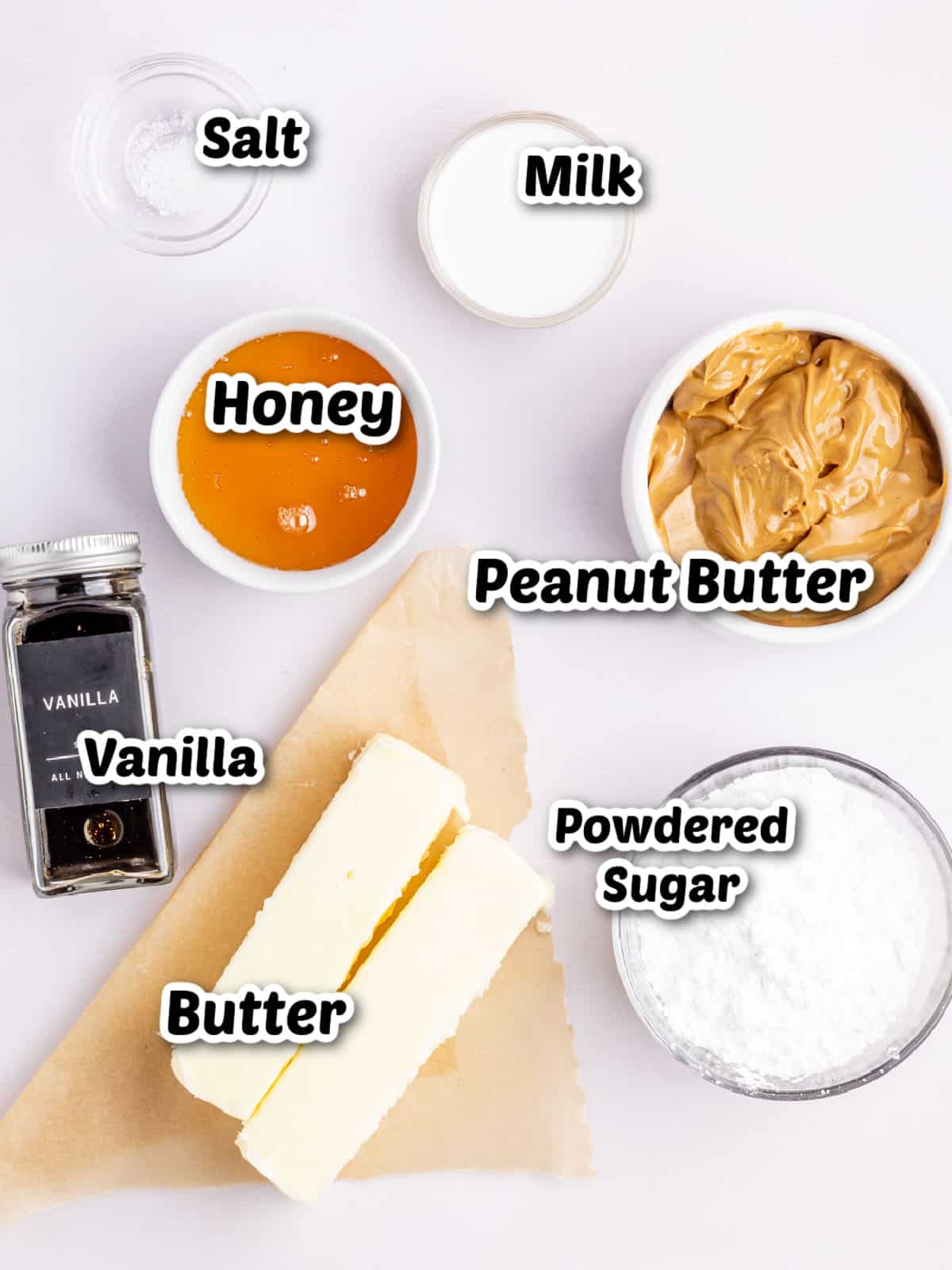 Ingredients laid out on a surface include salt, milk, honey, peanut butter, vanilla extract, butter, and powdered sugar.