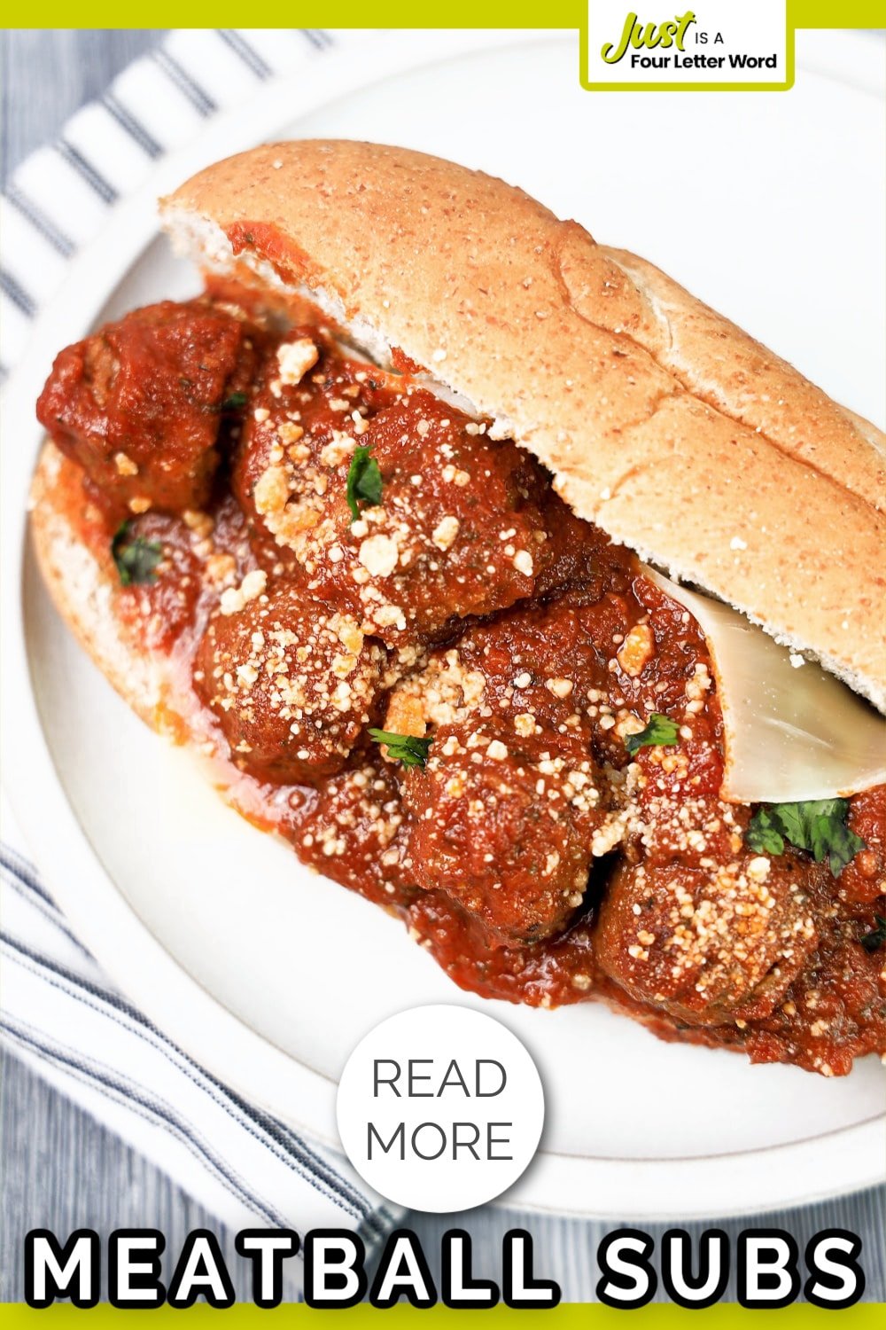 Meatball sub sandwich with tomato sauce and Parmesan cheese on a white plate. Text overlay reads "READ MORE MEATBALL SUBS.