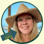 Woman in a straw hat smiling at the camera outdoors, with the words "Ask Andrea" on a graphic arrow in the lower left corner of the image.